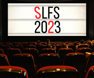 A movie theater screen says "SLFS 2023" in black and red letters