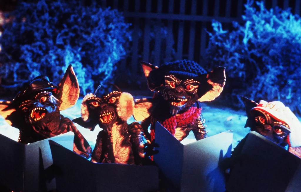 a still of gremlins caroling from the holiday movie Gremlins